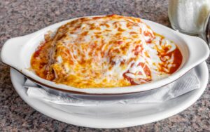 Lasagna topped with classic cheese, tomato sauce, and ground beef. Famous Pizza House 23 N Main St, Norwalk, CT 06854